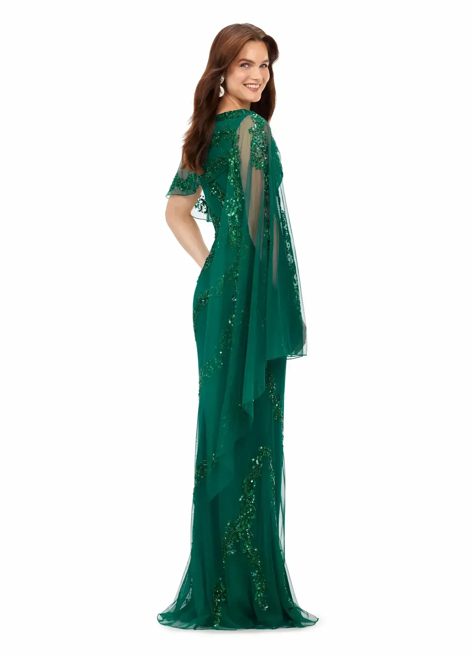 model is wearing an emerald green evening gown with beadwork and embroidery
