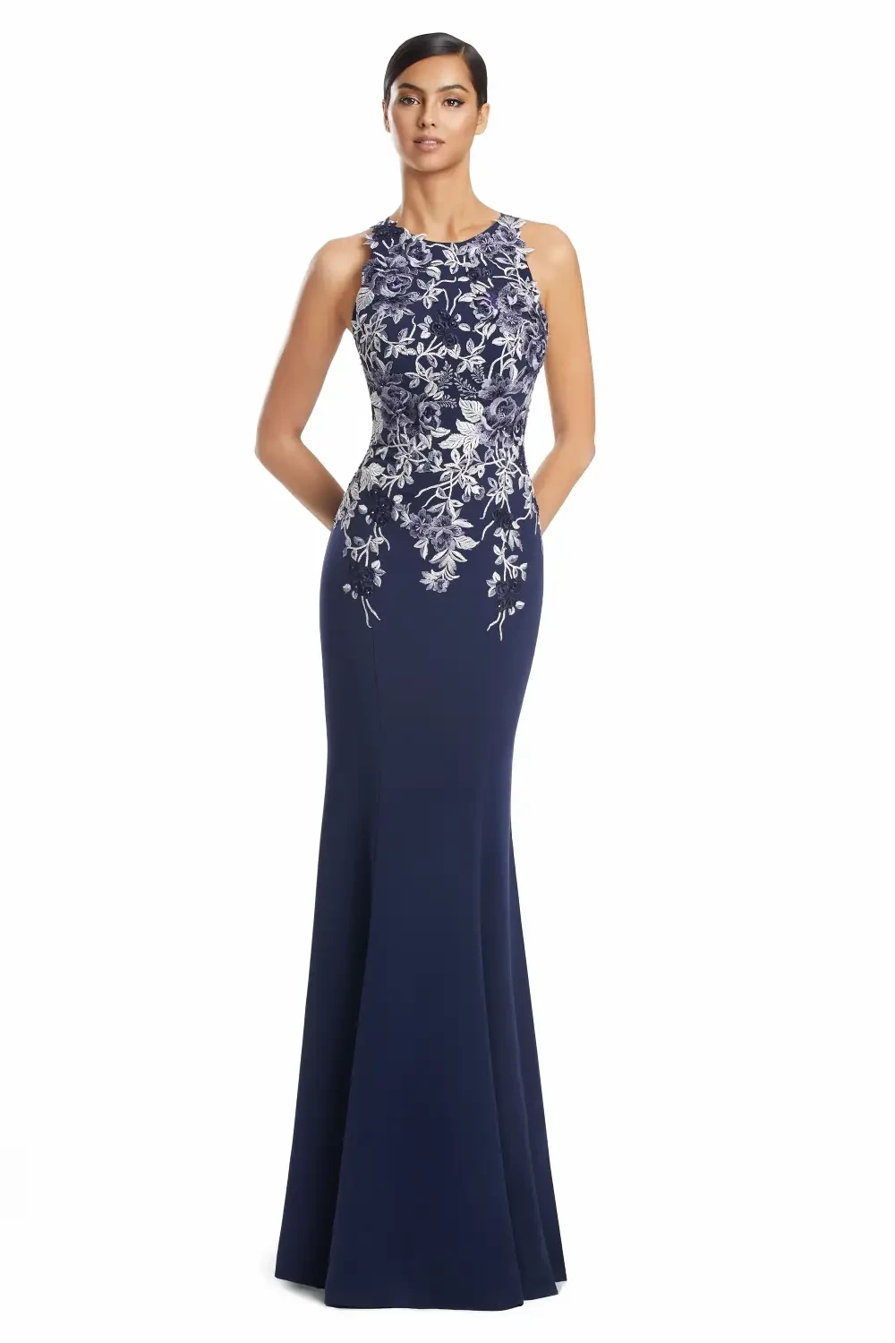 Woman wearing a fitted navy blue evening gown with floral embroidery.
