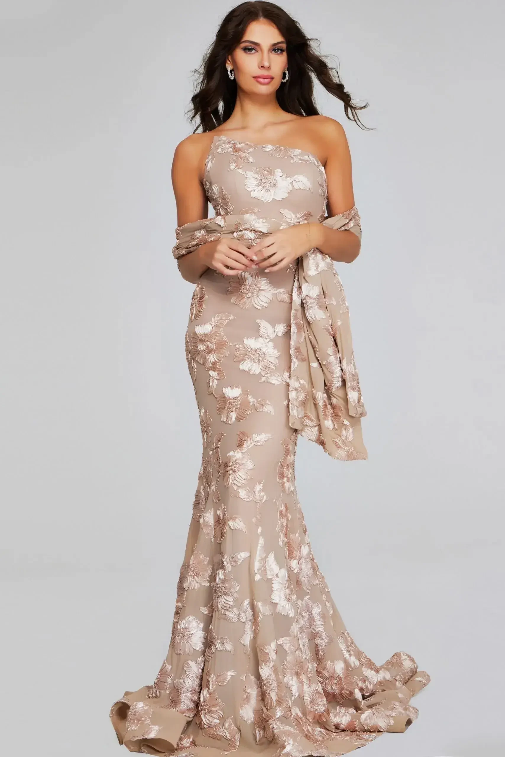model is wearing a champagne fit and flare evening gown with a scarf