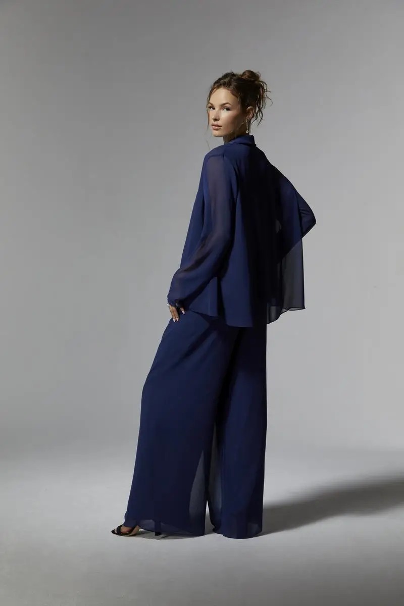 Model is wearing a three piece chiffon pant suit mothers outfit from morilee