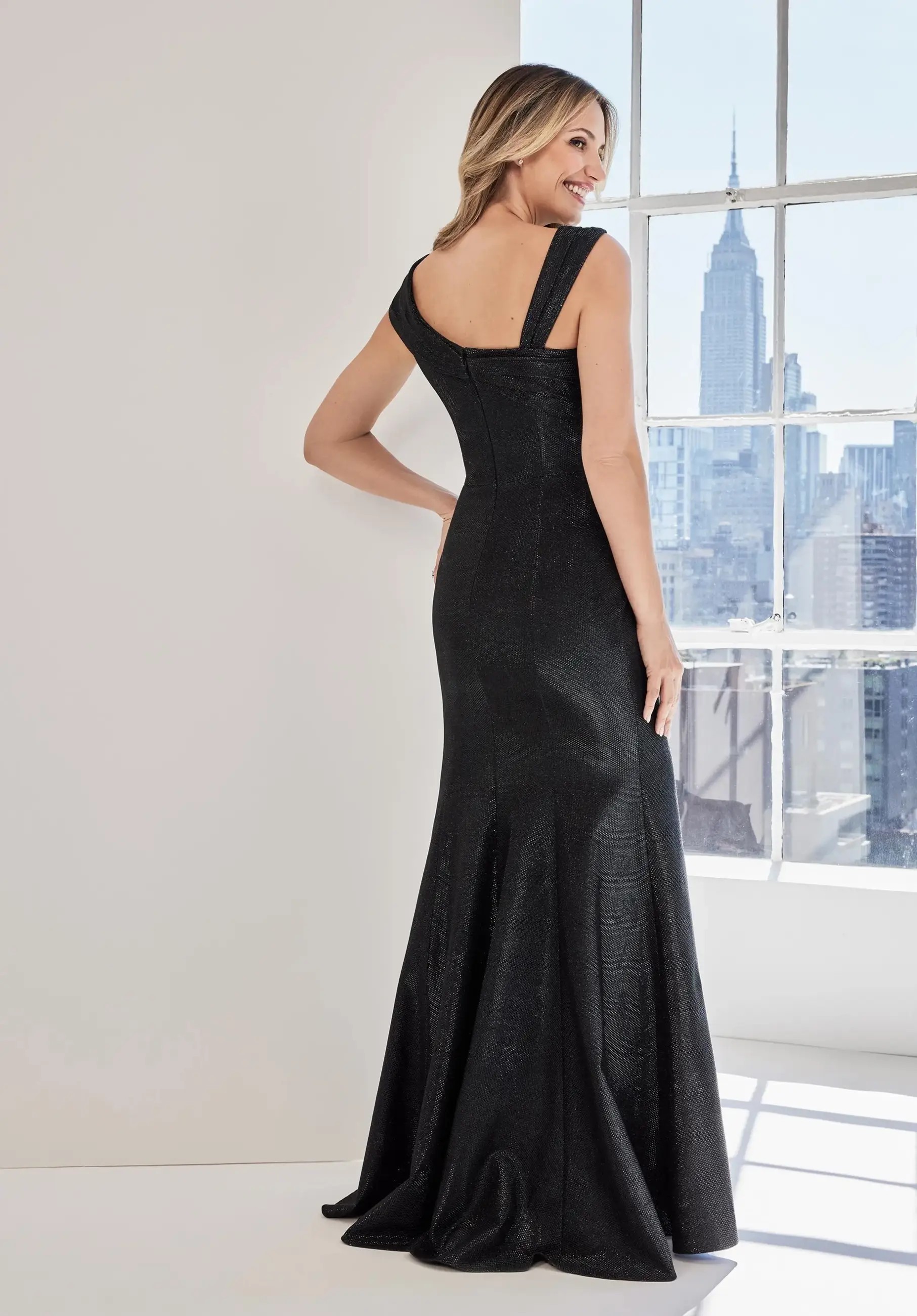 Model is wearing a metallic brocade mermaid dress with cap sleeves by morilee