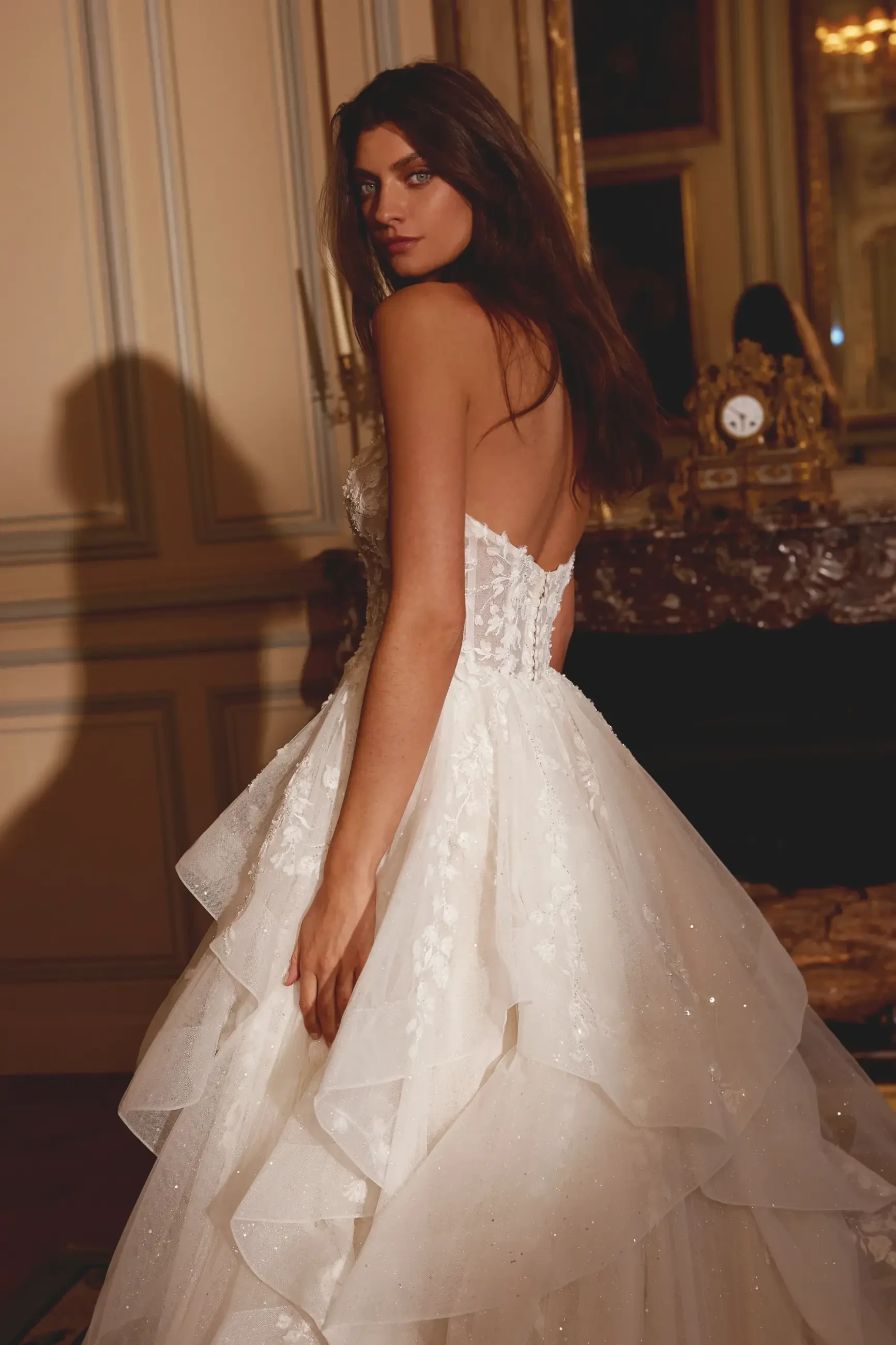 model is wearing a strapless ball gown wedding dress