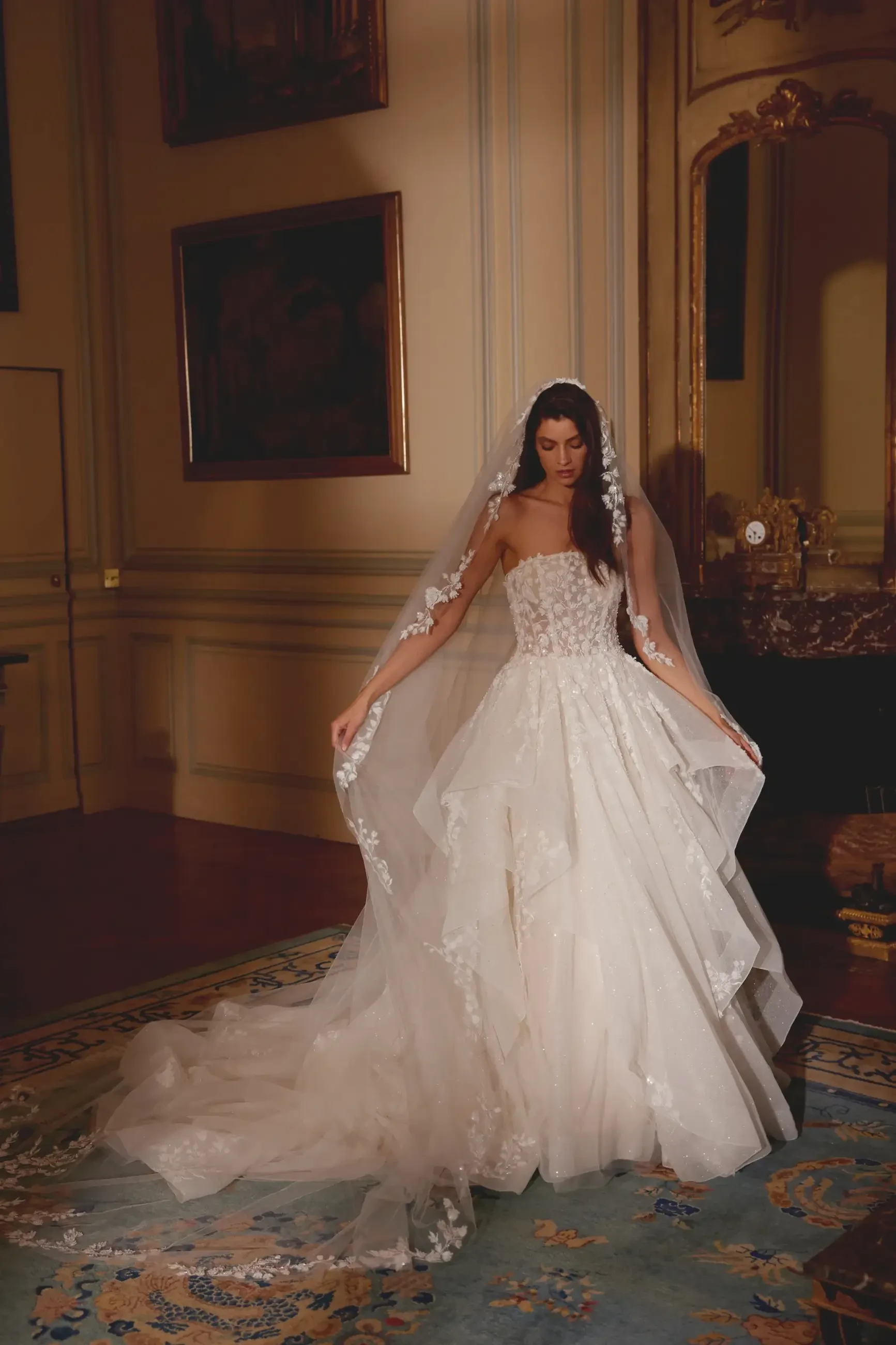 model is wearing a strapless ball gown wedding dress