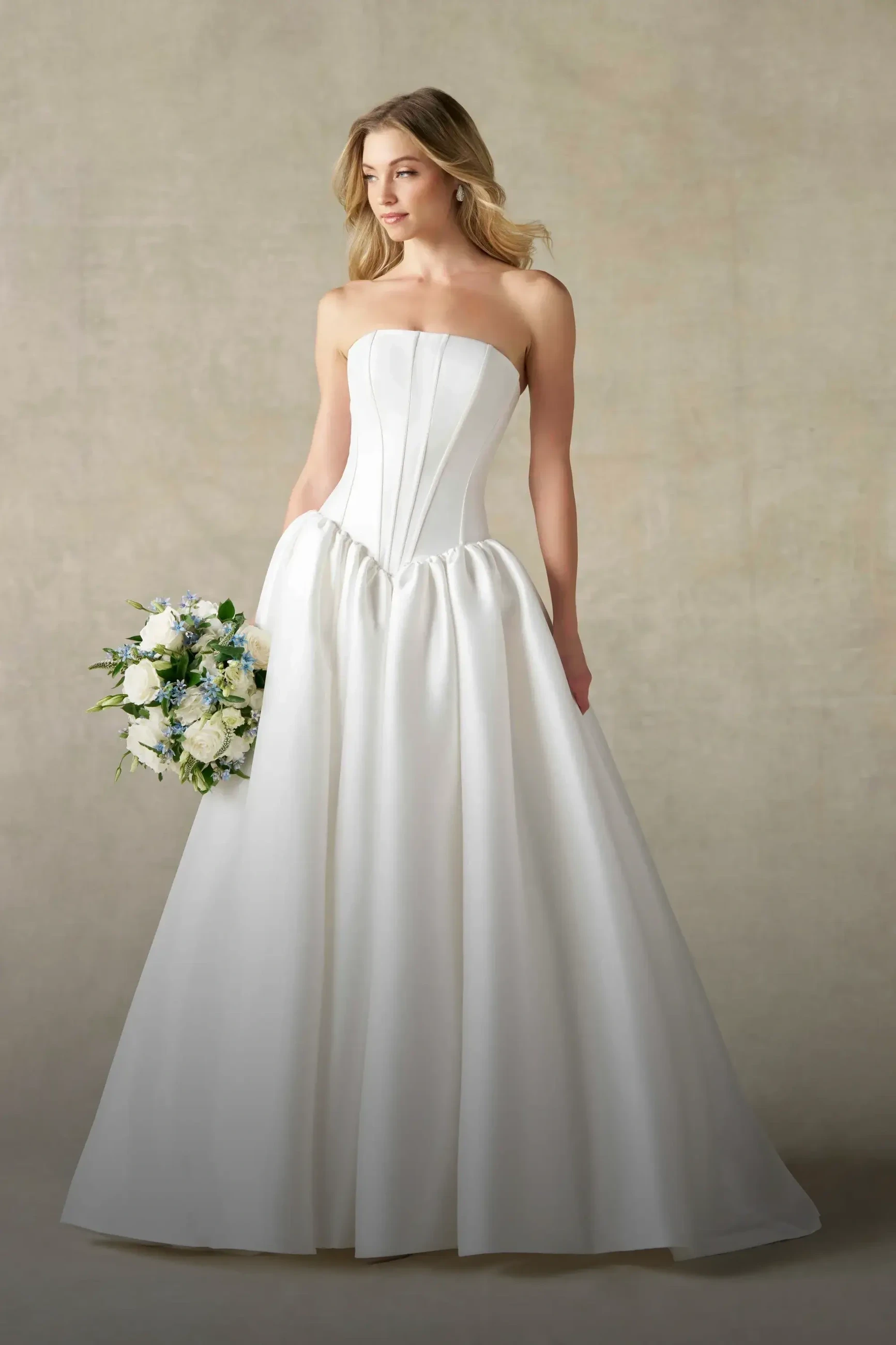 Model wearing a ballgown style dress