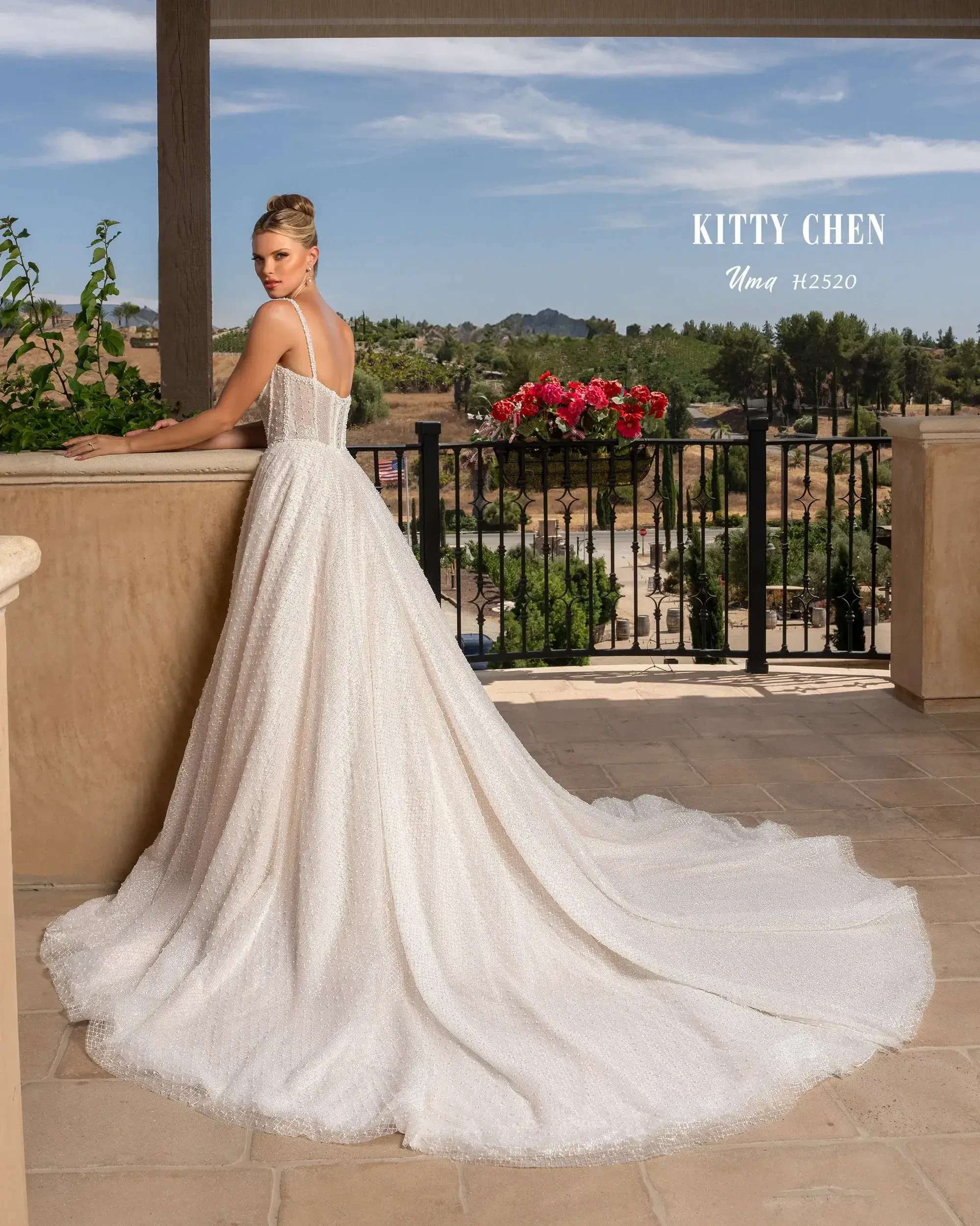 model is wearing a strapless ball gown wedding dress with a long train