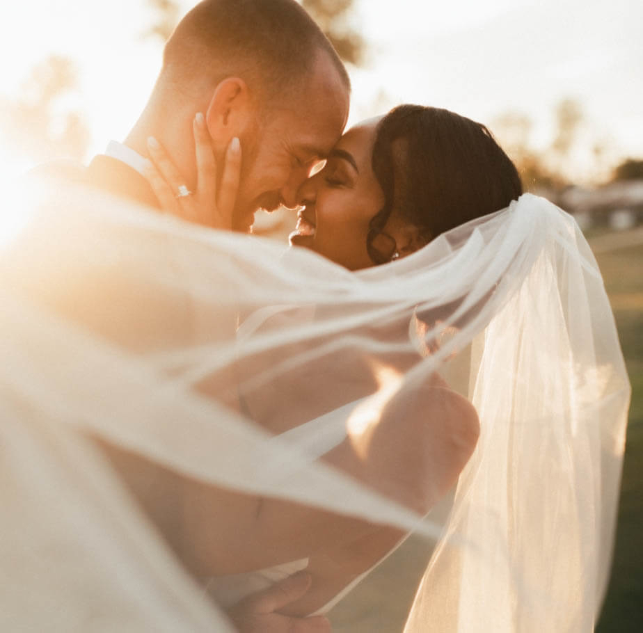 Сouple wearing a white gown and a black suit