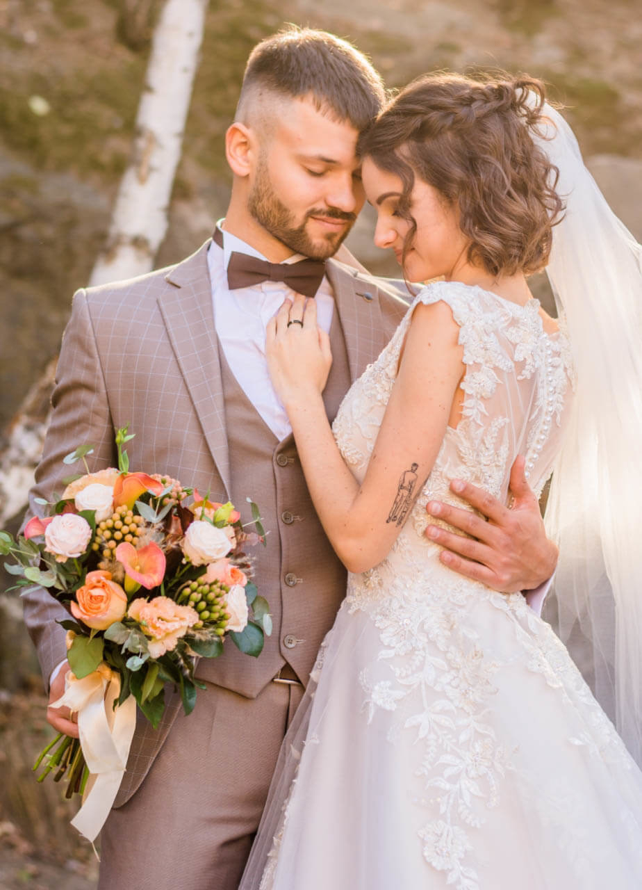 Сouple wearing a white gown and a gray suit