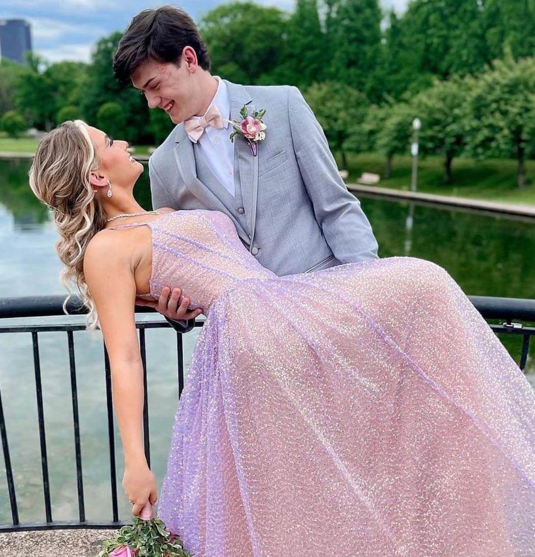 Сouple wearing a pink gown and a gray suit