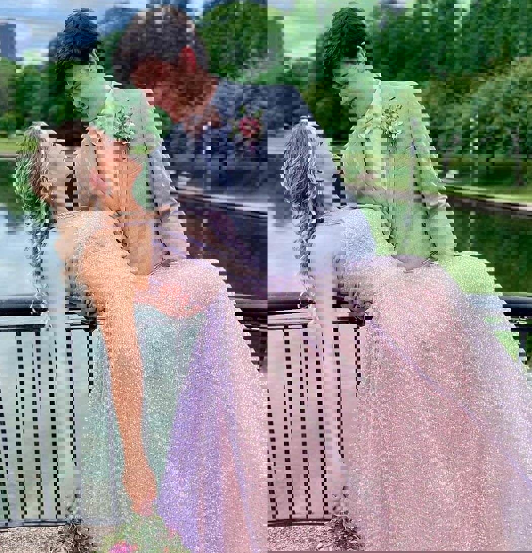 Сouple wearing a pink gown and a gray suit