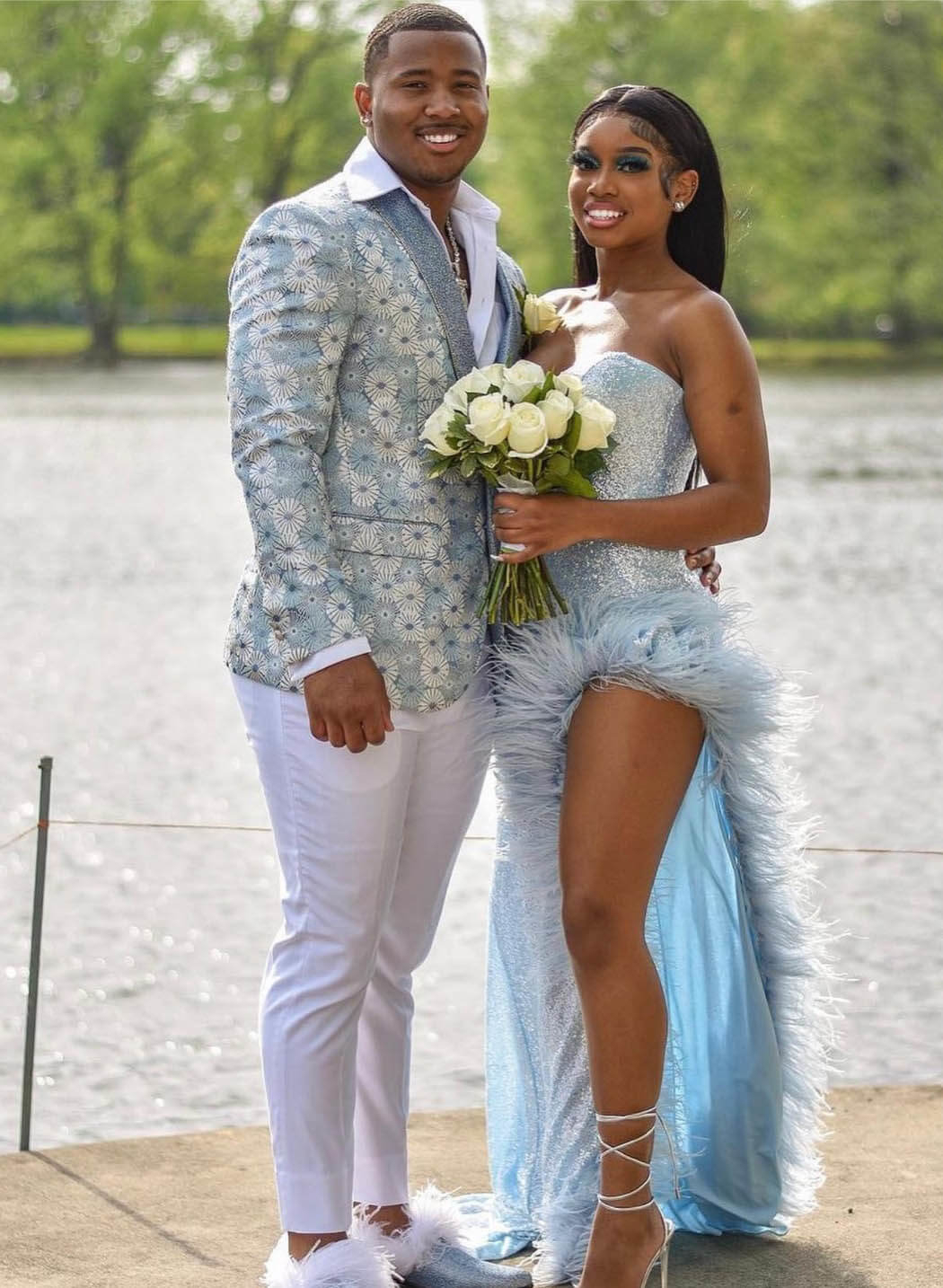 Сouple wearing a blue gown and a white suit
