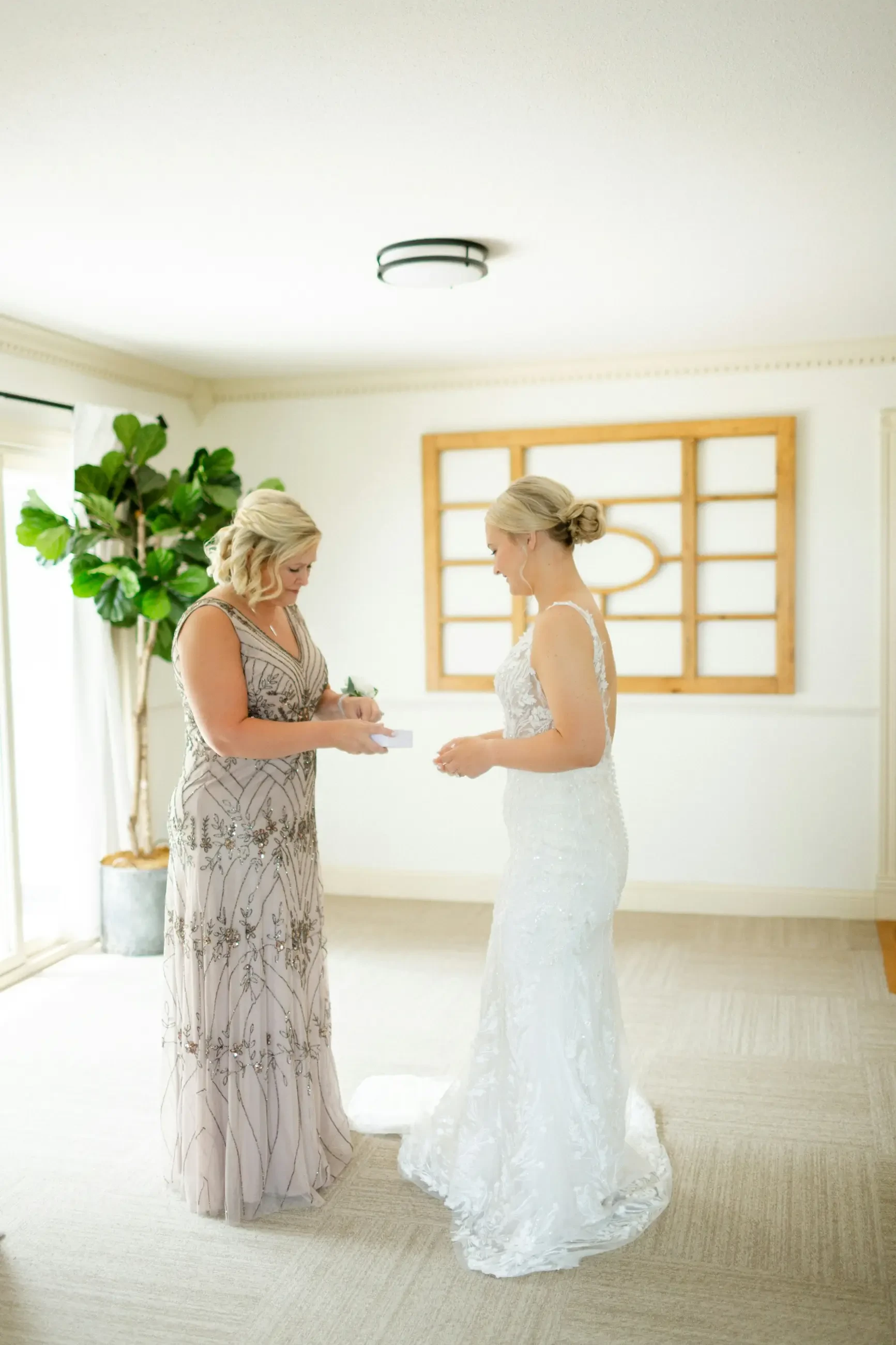 image shows a woman on her wedding day photographed with her mother