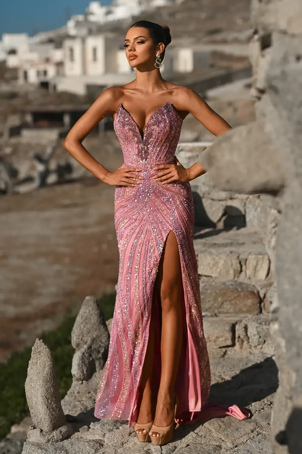 model is wearing a pink sparkly prom gown